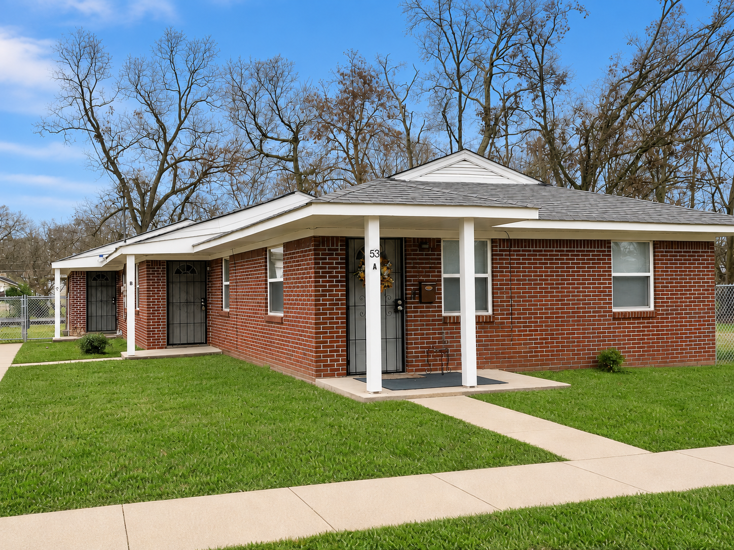 Brick home with a covered front porch and lawn in the Birmingham area